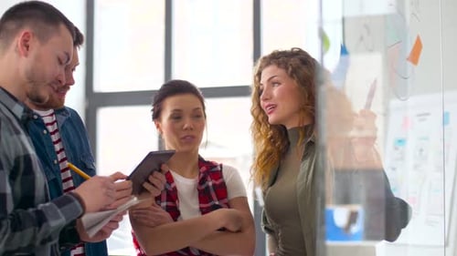 Creative Team with Tablet Pc and Charts at Office