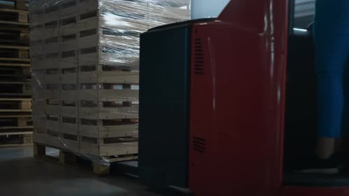 Forklift Moving Pallet of Crates in Warehouse