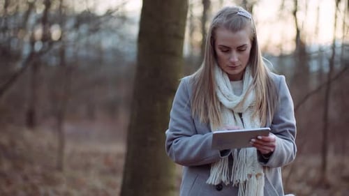 Woman Using Digital Tablet in Park
