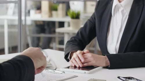 Business Handshake After Corporate Meeting in Bright Office