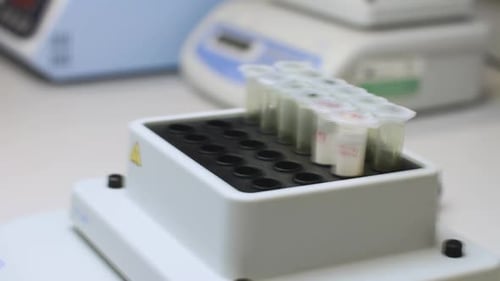 Test Tubes in Lab Setting Being Removed