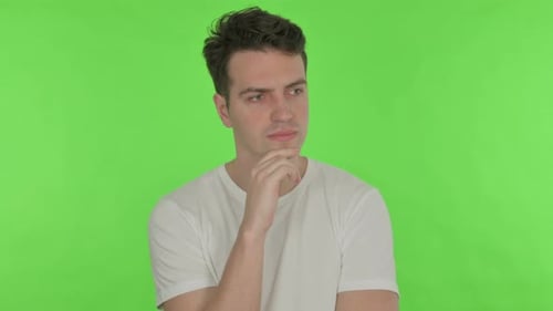 Thinking Young Man Brainstorming on Green Background