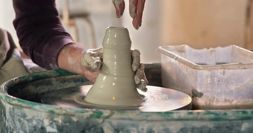 Adult Shaping Clay on a Pottery Wheel