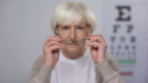 Senior Woman Puts on Glasses and is Happy