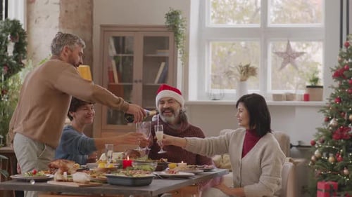 Family Christmas Celebration Champagne Pouring at Home