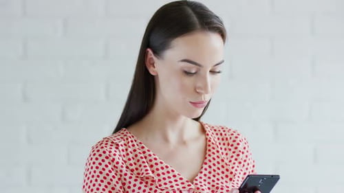 Young Woman Using Mobile Phone Indoors