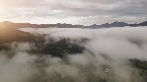 Aerial Fly Over Morning Fog in Mountain Village