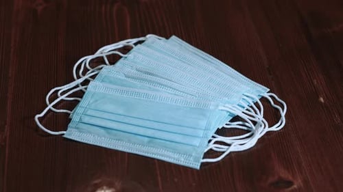 Stack of Blue Surgical Masks on Wood Surface