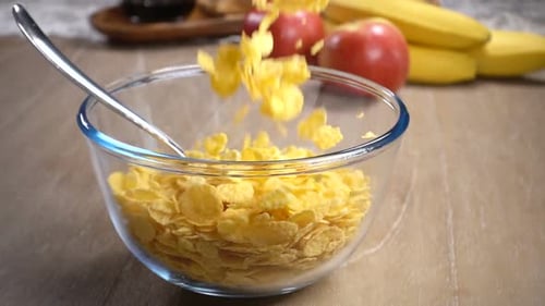 Crispy Cornflakes Pouring Into Bowl for Breakfast