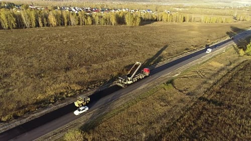 Aerial View. Road Repair. Loading the Asphalt Mixture Into the Paver. Freshly Laid Asphalt in the