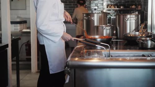 Chef Cooking Noodles in Commercial Kitchen