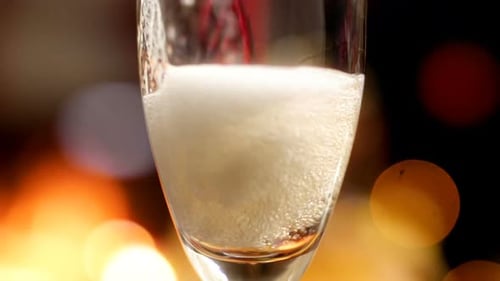 Champagne Pouring into Flute Glass at Night