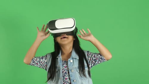 Excited Child Using Virtual Reality Headset on Green Screen