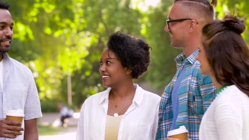 Happy Friends Drinking Coffee and Talking in Park 78