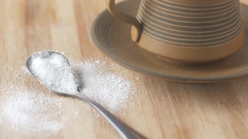 Sugar Substitute Sweetener and Tea Cup on Table