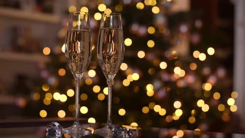 Champagne Glasses with Christmas Tree Background