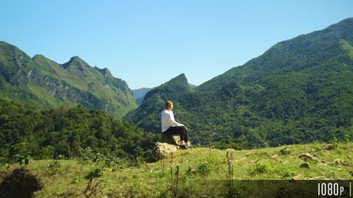 Woman Walking on Top of a Mountain Range to Enjoy Beautiful View
