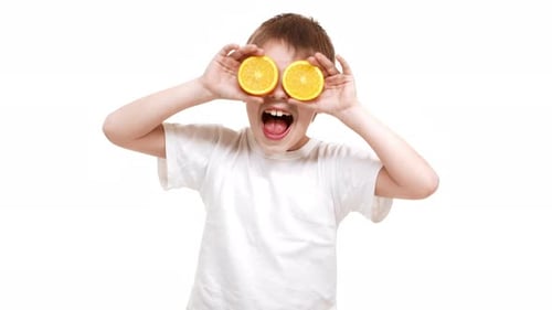 Cute Boy Plays With Orange Halves