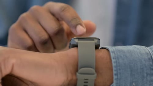 Close Up of African Male Hands Using Smartwatch