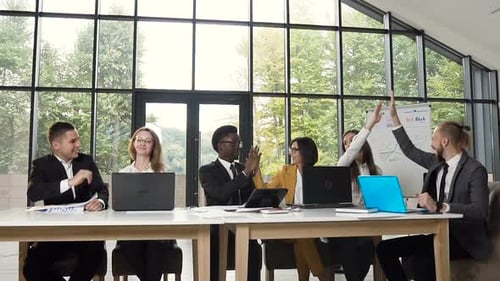 Team Celebrates Success with High Fives in Office