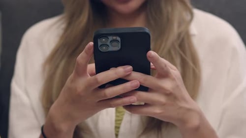 Woman's Hands Holding and Using Smartphone