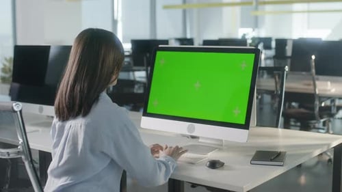 Business Woman Working In Office Interior On Pc On Desk Looking At Display Green Screen