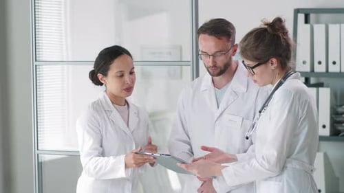 Group of Professional Doctors Having Discussion in Clinic