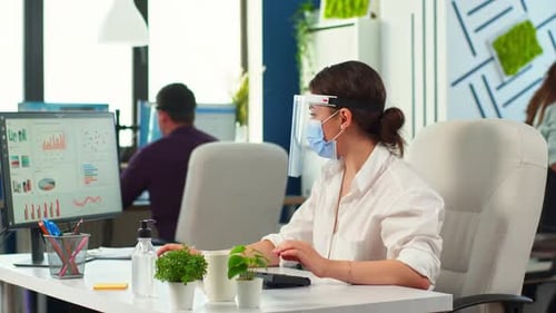 Young Adult Woman Working in Office with Safety Measures