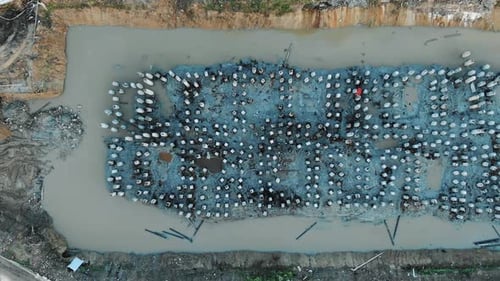 High Piles Covered with Grey Concrete Poured Into Quarry