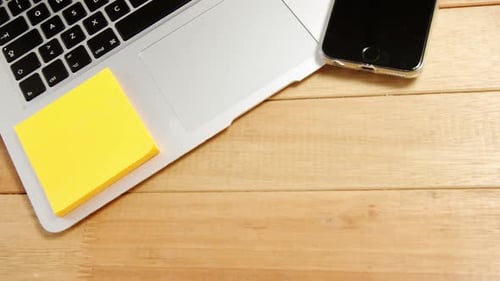 Laptop, Phone and Sticky Notes on Desk