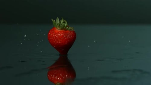 Red Strawberry Standing in Still Water Reflecting