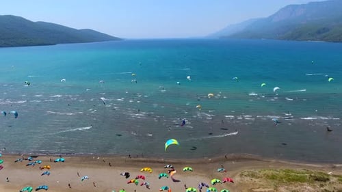 Kiteboarding, Kitesurfing Kiters and Kiteboarders are Pulled Across Sea Water by a Wind Power Kite