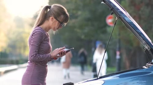 Woman with Car Trouble Talks on Phone