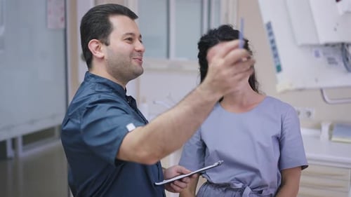 Doctor Consults with Young Woman in Hospital Setting