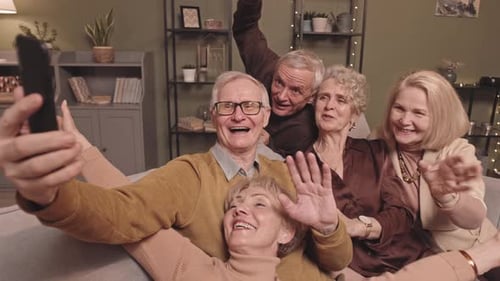 Seniors Smiling and Taking Selfie on Couch