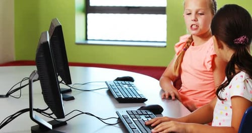 Girls Learning on Computers in a Classroom
