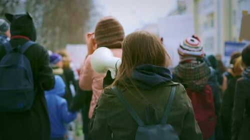 People Protesting in Urban Area with Megaphone