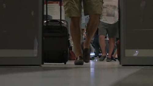 People walking out airport terminal
