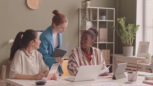 Team of Women Collaborating at Office Desk