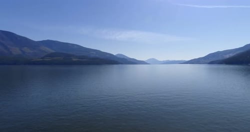 Beautiful lake surrounded by rocky mountain range 4k