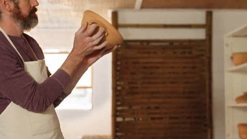 Potter Creates Ceramic Pot in Sunny Studio