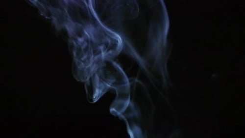 Isolated Smoke Stream Curling Against Black Background