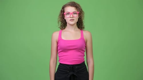 Young Woman Posing in Front of Green Screen