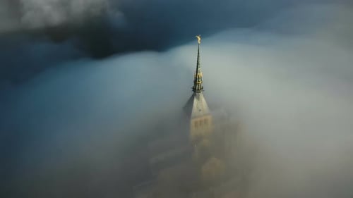 Beautiful Aerial Shot of Thick Fog Covering Mystic Ancient Castle of Sunrise Mont Saint Michel at