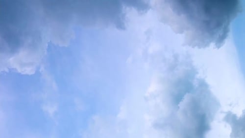 Seamless Loop Fluffy Clouds in Blue Sky in Summer Shot on a Sunny Day