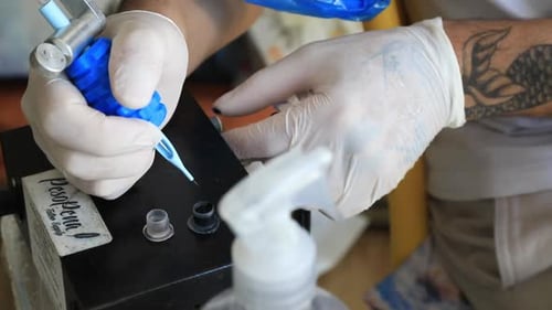 Tattoo Artist Creates Tattoo On Customer's Arm