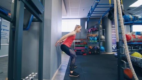 Athletic Woman Performing Wall Sit Exercise