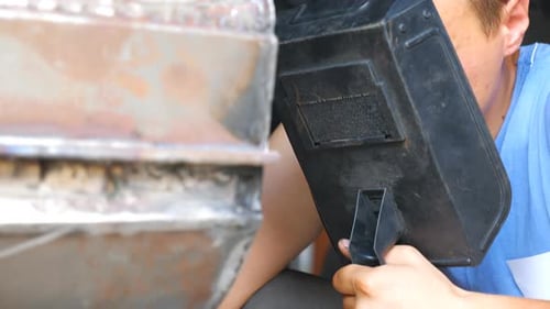Welder Working on Metal in Workplace