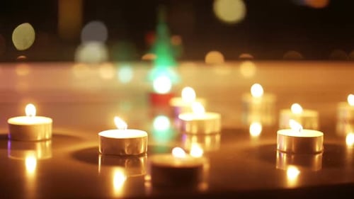 Glowing Candles and Christmas Tree Creating Holiday Ambiance