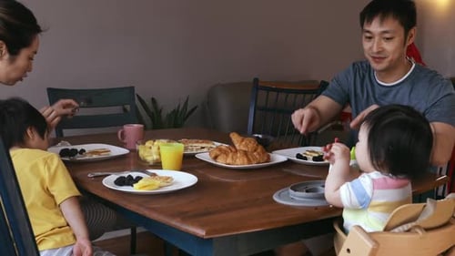 Family Enjoys Meal Together at Home